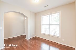 Fuquay Varina house for rent - A room with a window and wooden floors.