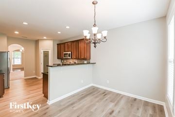 Fuquay Varina house for rent - A well-lit kitchen with wooden cabinets and a chandelier.