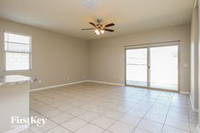 Florence house for rent - A spacious room with a ceiling fan and sliding glass doors.