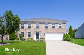 Noblesville house for rent - a brick house with a white garage door