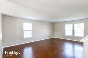 Noblesville house for rent - the living room of an empty house with wood floors