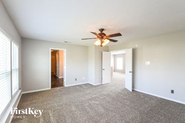 Noblesville house for rent - a living room with carpet and a ceiling fan