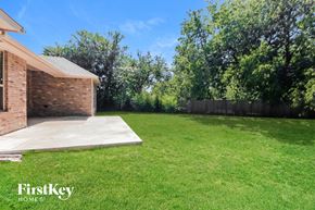 Norman house for rent - a backyard with a grass lawn and a house