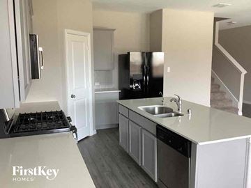 Forney house for rent - a kitchen with a sink and a stove and a refrigerator