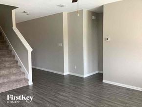 Forney house for rent - an empty living room with gray walls and a staircase