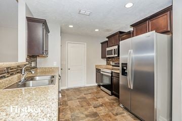 Murfreesboro house for rent - a kitchen with stainless steel appliances and granite counter tops