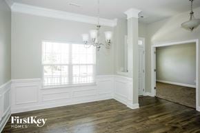 Locust house for rent - a renovated living room with white walls and wood floors