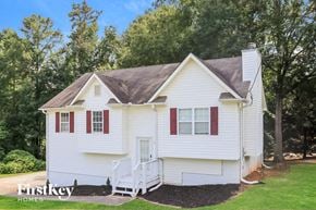 Temple house for rent - a white house with red shutters and a lawn and trees