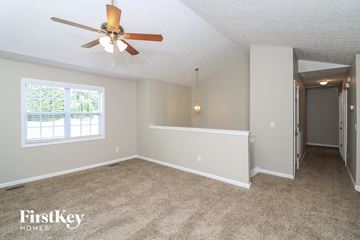 Temple house for rent - a living room with carpet and a ceiling fan