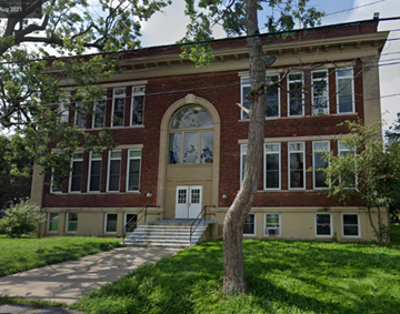 Albany apartment for rent - the front of a red brick school building with a tree in front