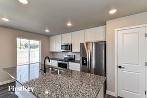 Colorado Springs house for rent - A kitchen with granite countertops and stainless steel appliances.