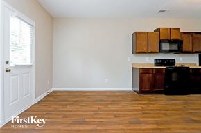 Hampton house for rent - an empty kitchen with wood flooring and a refrigerator and a microwave