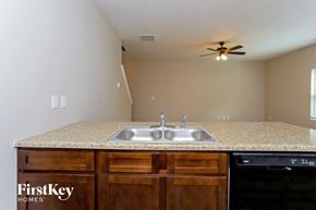 Hampton house for rent - a kitchen with a sink and a ceiling fan