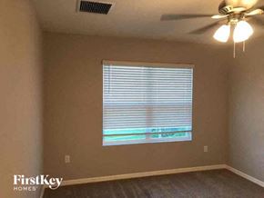 Fort Myers house for rent - a living room with a window and a ceiling fan
