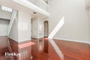 Kissimmee house for rent - an empty living room with wood floors and white walls