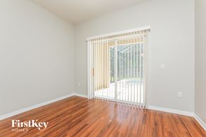 Kissimmee house for rent - a living room with wood floors and a sliding glass door