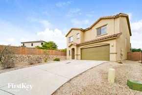 Tucson house for rent - a house with a driveway and a garage door