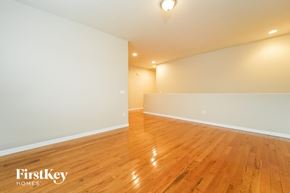 Tucson house for rent - the living room and dining room of a house with wood floors and white walls