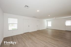 San Antonio house for rent - A spacious room with wooden flooring and white walls.