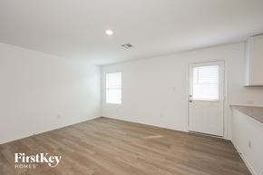 San Antonio house for rent - A room with wooden flooring and a white door.