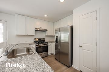 San Antonio house for rent - A kitchen with a stainless steel refrigerator and a sink.