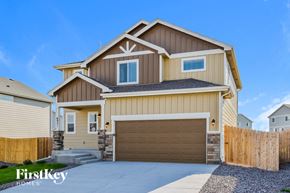 Colorado Springs house for rent - a tan and brown house with a garage door