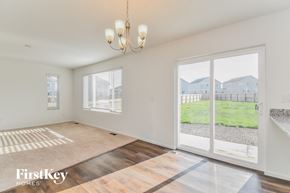 Colorado Springs house for rent - an empty living room with a sliding glass door to a yard