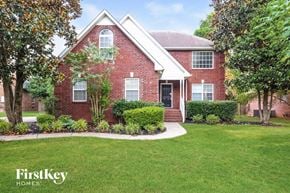 Murfreesboro house for rent - A red brick house with a white trim and a small porch.