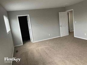 Lochbuie house for rent - a room with a carpeted floor and a white door