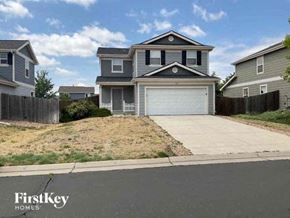 Lochbuie house for rent - a house with a white garage door and a driveway