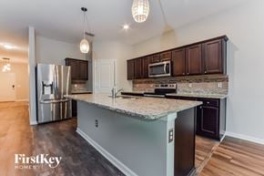 Davenport house for rent - A kitchen with a granite countertop and a refrigerator.