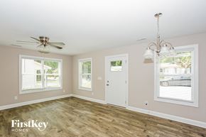 Concord house for rent - a living room with wood floors and a ceiling fan