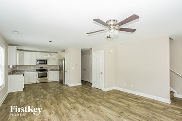 Concord house for rent - a kitchen with white cabinets and a ceiling fan