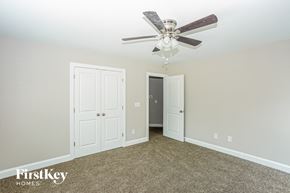 Concord house for rent - a bedroom with a ceiling fan and a door to a closet