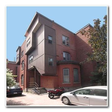 Ottawa apartment for rent - a building with a motorcycle and a car parked in front of it