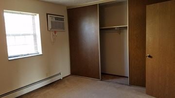 Stow apartment for rent - a bedroom with a closet and an air conditioner