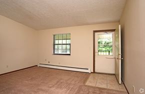Stow apartment for rent - the living room of an empty house with a door to a window