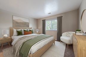 Indianapolis apartment for rent - a bedroom with a bed and a chair and a window