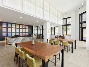 Savannah apartment for rent - a communal area with tables and chairs and a kitchen in the background