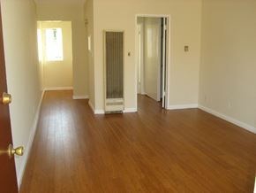 Los Angeles apartment for rent - an empty living room with a hard wood floor and a closet