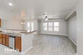 San Antonio house for rent - A spacious kitchen with wooden cabinets and a marble countertop.