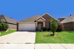 Little Elm house for rent - a small brick house with a white garage door