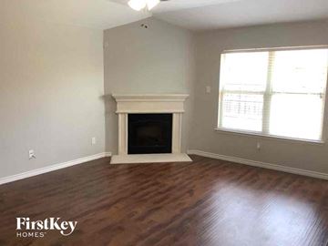Little Elm house for rent - a living room with a fireplace and wooden floors