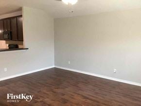 Little Elm house for rent - an empty living room with white walls and wood floors