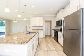 Jacksonville house for rent - A kitchen with a granite countertop and stainless steel appliances.