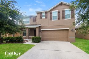 Melbourne house for rent - a beige house with a garage door and a driveway