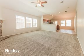 Forney house for rent - A spacious room with a carpeted floor and a ceiling fan.