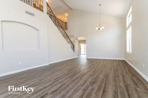 Buckeye house for rent - an empty living room with white walls and wood flooring