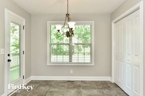 Clarksville house for rent - a dining room with a large window and a white door