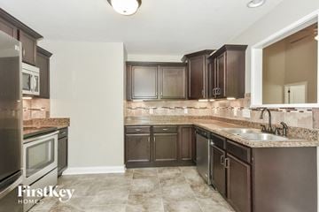 Clarksville house for rent - a kitchen with stainless steel appliances and granite counter tops
